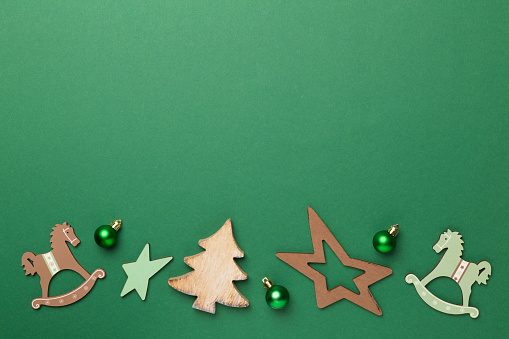 Wooden Christmas toys on color background, top view.