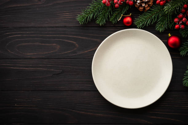 istock Christmas table setting with plate, cutlery and christmas decorations on white background. 1644111278
