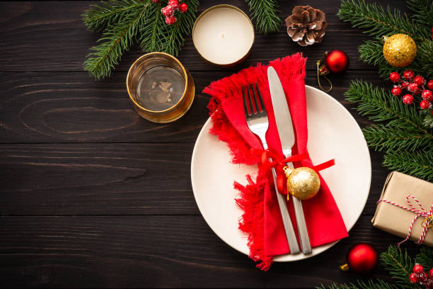 istock Christmas table setting with plate, cutlery and christmas decorations on white background. 1644111566