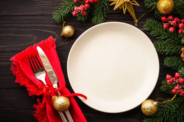istock Christmas table setting with plate, cutlery and christmas decorations on white background. 1644111810