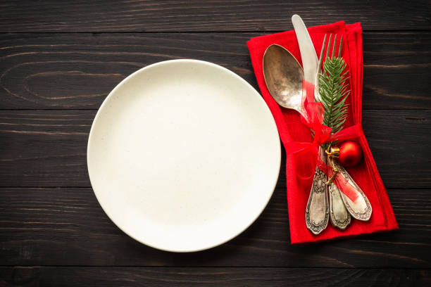 istock Christmas table setting with plate, cutlery and christmas decorations on white background. 1644111867