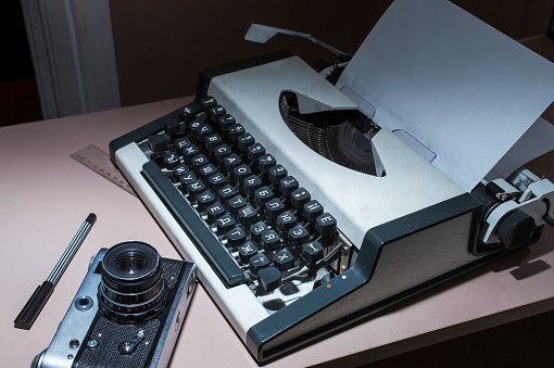 an old typewriter with the camera on the table