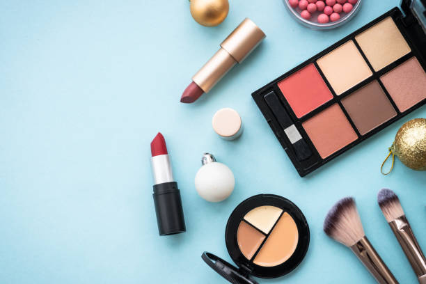 istock Make up products and christmas decorations on blue background. 1644116941