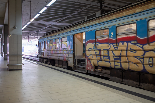 A graffiti-strewn old train passes through the Prokop underground main railway station in Belgrade, Serbia