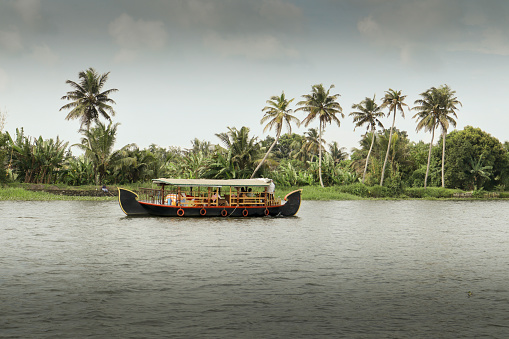 Kochi, Kerala, India-October 9 2022; The House boat traditionally built with wood and coir is a major attraction for the travellers visiting Keral backwaters for Eco tourism in Kochi, India.