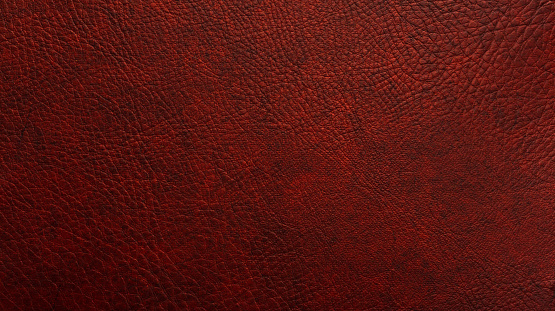 Detailed background of vintage leatherette in shades of maroon, red, brown and black.