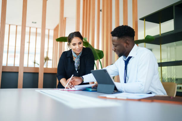 istock Diverse business people on meeting table 1644143443