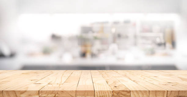 istock Selective focus.Wood table top on blur kitchen counter background.For montage product display or design key visual layout. 1644144004