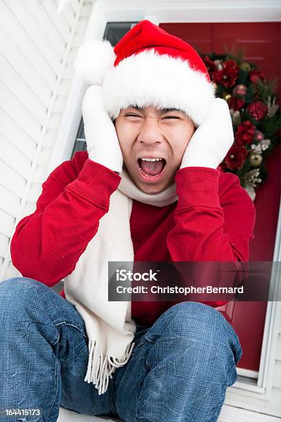 Christmasfrustrated Asian Man Sitting On His Door Steps Stock Photo - Download Image Now