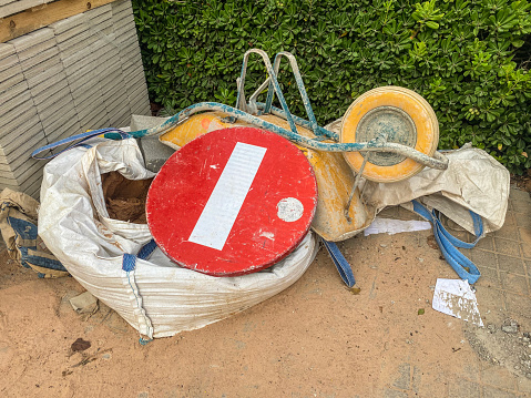 High angle view of no entry sign over construction materials and equipment in the street