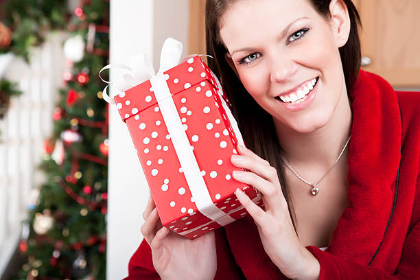 istock Smiling woman holding christmas present 164416140
