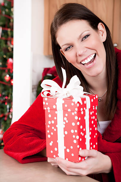 istock Smiling woman holding christmas present 164416339