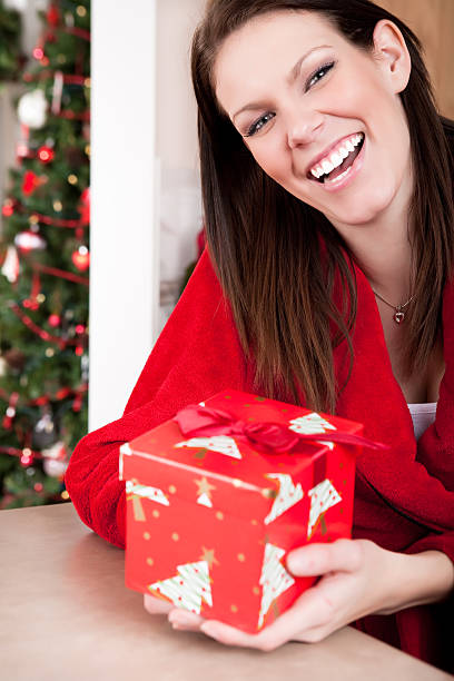 istock Smiling woman holding christmas present 164416538