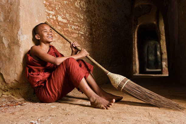 Novice Buddhist monk resting inside the temple in Bagan, Myanmar