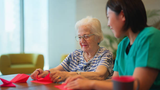 istock Senior woman learning making origami as for physiotherapy activity 1644169398