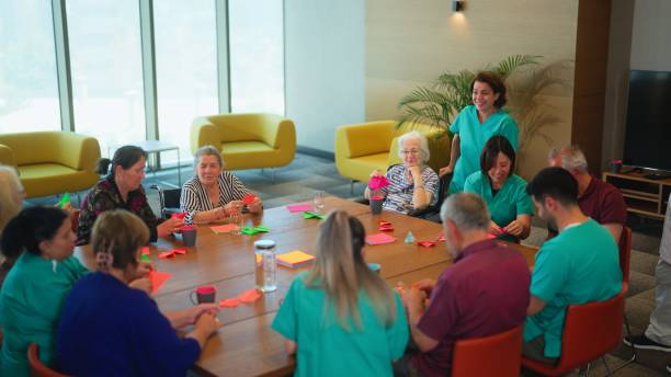istock Group of senior people enjoying learning and doing craft in nursing home. 1644170842
