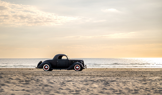 Very nice old black classic car, three-window coupe. Year of construction 1936. On the beach in Rømø Denmark.