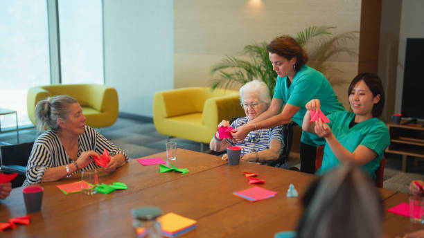 Group of senior people enjoying learning and doing craft in nursing home.