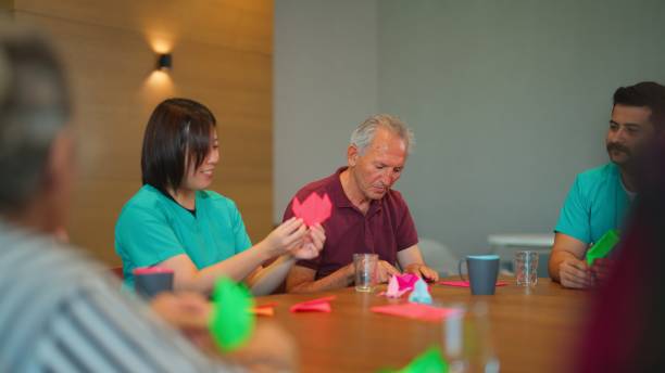 istock Group of senior people enjoying learning and doing craft in nursing home. 1644171599