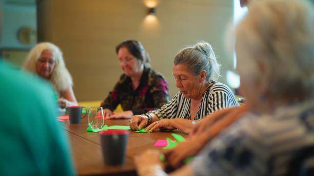 istock Group of senior people enjoying learning and doing craft in nursing home. 1644172221