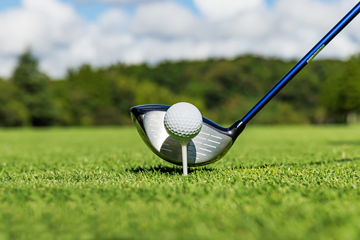 Drone perspective view of a golfer lining up a putt on the green. Shot on location on a golf course on the island of Moen in Denmark. Horizontal format with some copy space.