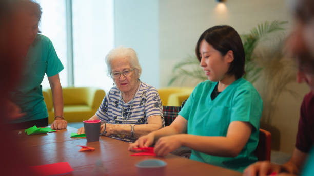 istock Group of senior people enjoying learning and doing craft in nursing home. 1644175075