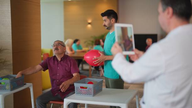 istock Doctor using digital tablet to record his patient's progress for physiotherapy in nursing home 1644179879