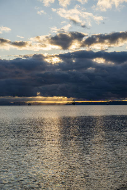 istock Sunset over the sea with dramatic clouds and reflections on the water 1644180394