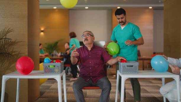 istock Senior man doing physiotherapy activity in nursing home 1644181548