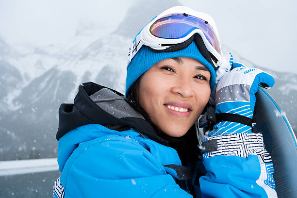 istock Smiling asian woman snowboard portrait 164418209