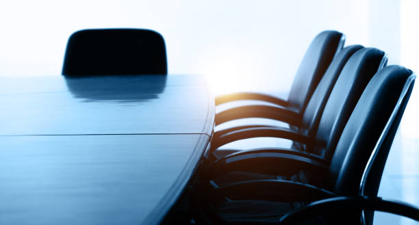 Conference table and chairs in empty meeting room stock photo