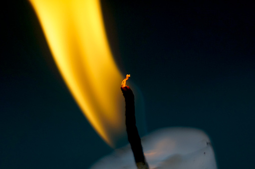 Burning candles on dark background close up