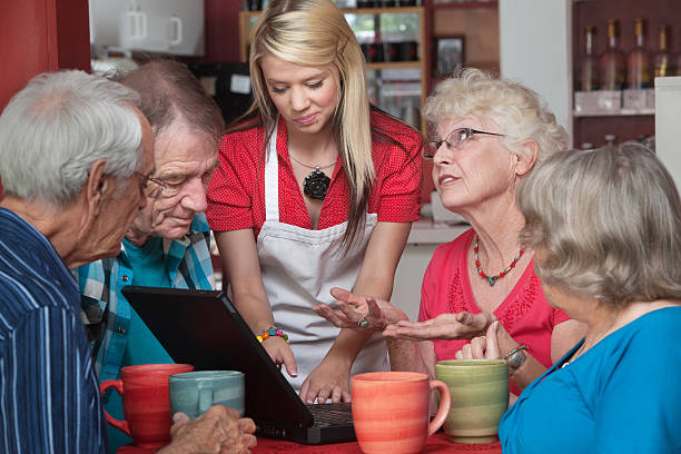 istock Woman Helping Seniors with Computer 164424992
