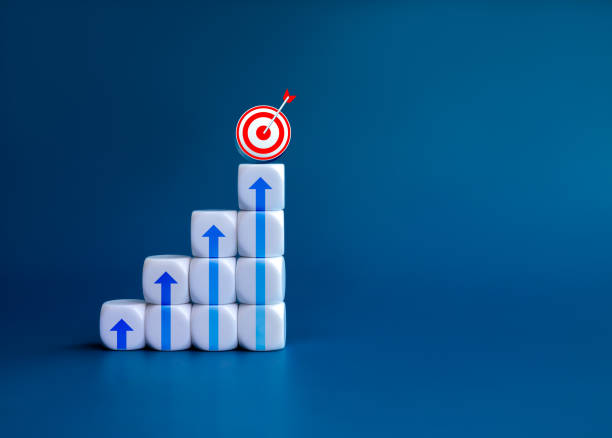 istock 3d Goal target icon and arrows on white blocks as business chart steps on blue background with copy space. The business growth graph process, goal, success, economic improvement and analysis concepts. 1644254635