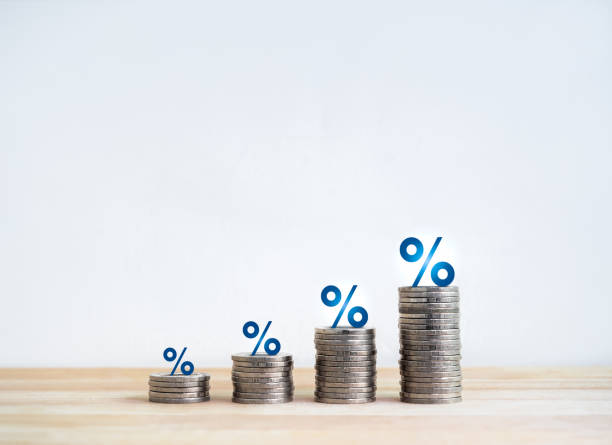 istock Blue percentage icon on coin stacked as a bar graph chart steps isolated on wood table, white background. Investment, profit, benefit, income, banking, business growth, economic improvement concepts. 1644255180