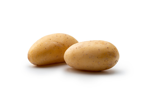 Two raw washed potatoes isolated on white background