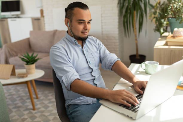 istock Man working on a laptop at home 1644283059