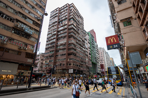 Hong Kong - August 28, 2023 : Pedestrians walk past the Nathan Road in Yau Ma Tei, Kowloon, Hong Kong.