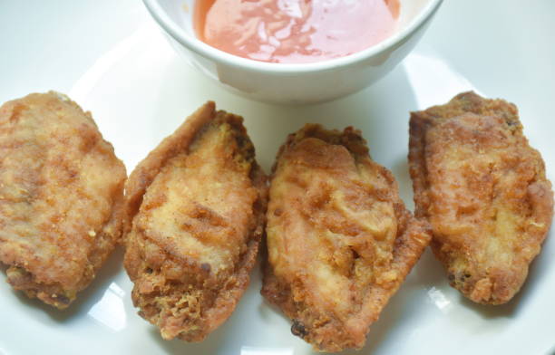 istock crispy fried chicken wing dipping chili sauce on plate 1644311125