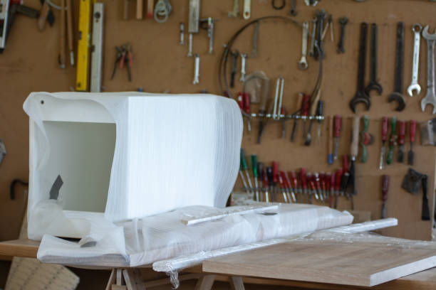 istock Packing carpentry products in white protective film in a small workshop 1644312759