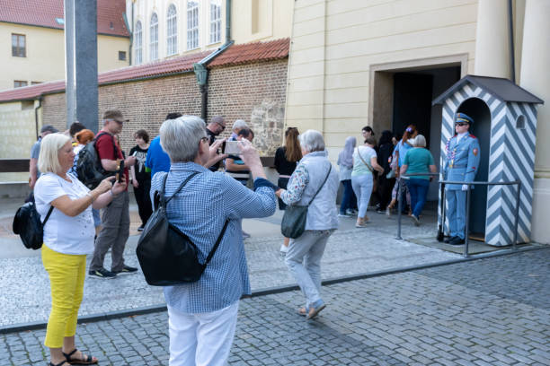 turistas tomando fotos de una guardia del castillo de praga - tourist photographing armed forces military fotografías e imágenes de stock