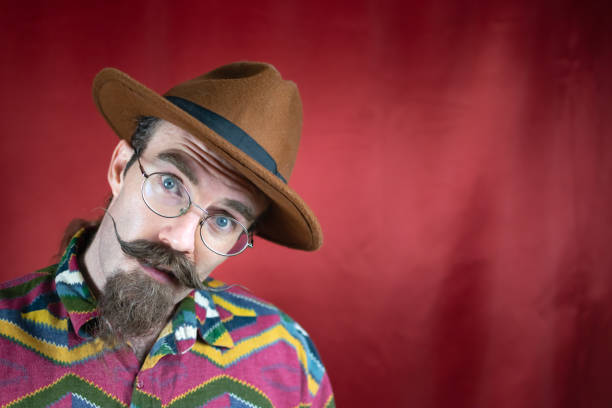 istock Vintage Hipster man with mustache, glasses, brown hat and asking expression 1644320944