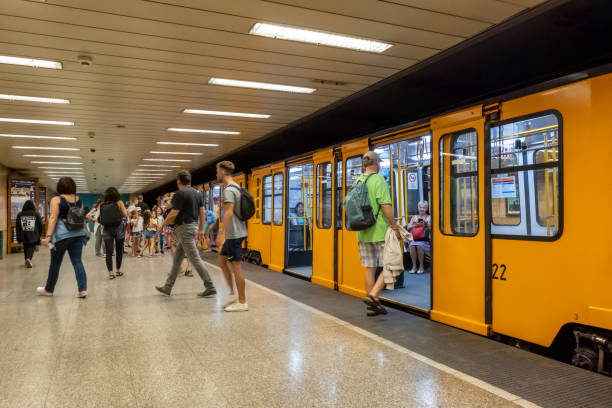 Budapest, Hungary - 3 September 2022: Passengers boarding the yellow train wagons of Budapest subway