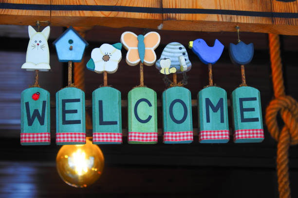welcome hand written text on paper hanging on cafe door