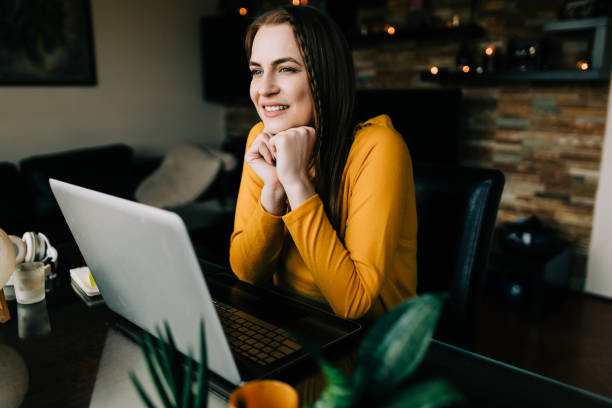 istock Young woman working from home and using a laptop 1644327130