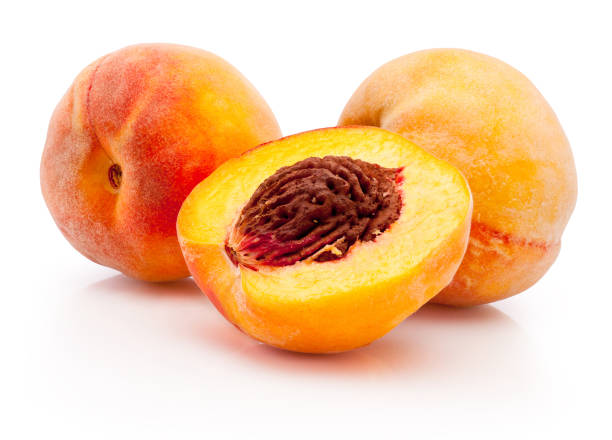 istock Peaches half and whole isolated on white background 1644333536