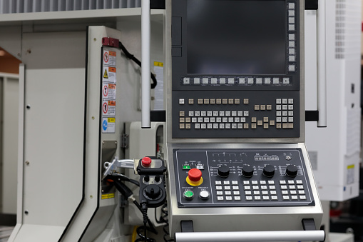 Control console of 5 axis CNC machining center. Selective focus.