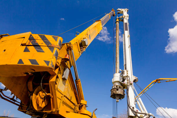 istock Mobile crane and drilling machine working together on bridge foundation 1644340704