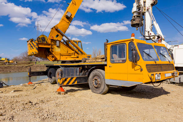 istock Mobile crane and drilling machine working together on bridge foundation 1644341175
