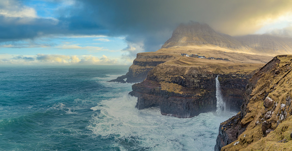 Gásadalur, Vágar, Faroe Islands: The village of Gásadalur, surrounded by the highest mountains on Vágar, enjoys a panoramic view over the isle of Mykines. In Gásadalur you will find Múlafossur waterfall. This is one of the most spectacular views in the Faroe Islands as the waterfall just falls off the cliffs. Above the village is the highest mountain of Vágar Island, called Árnafjall.